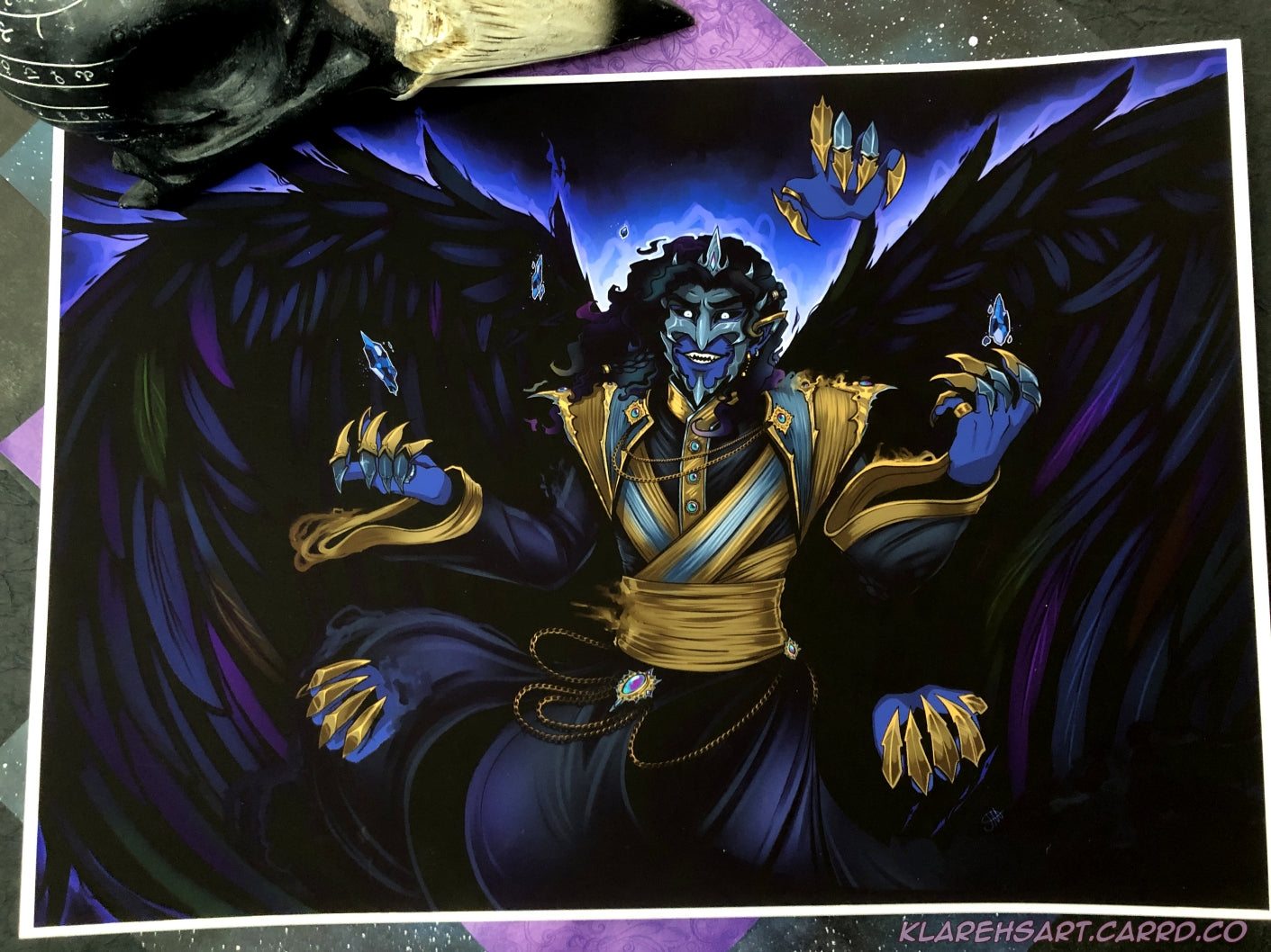 Colorful illustration of Ozul, an original character in Beyond the Stillwall. Ozul appears as a shadow like being with raven wings, 5 visible hands, with 3 of the hands floating detached. He is wearing indigo, black, and silver attire. His face is covered in a sharp metal mask.